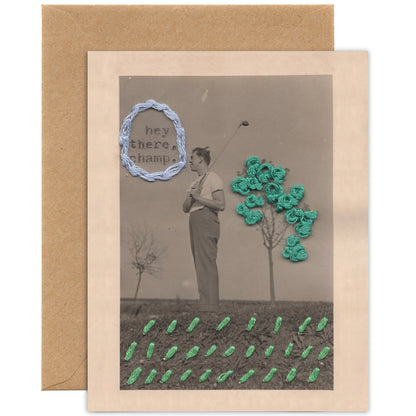 Greeting card with a man holding a golf club and flowers, with 'hey there, champ' text, on a brown envelope.