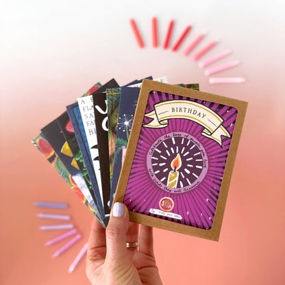 Hand holding a colorful card with a purple design against a gradient background