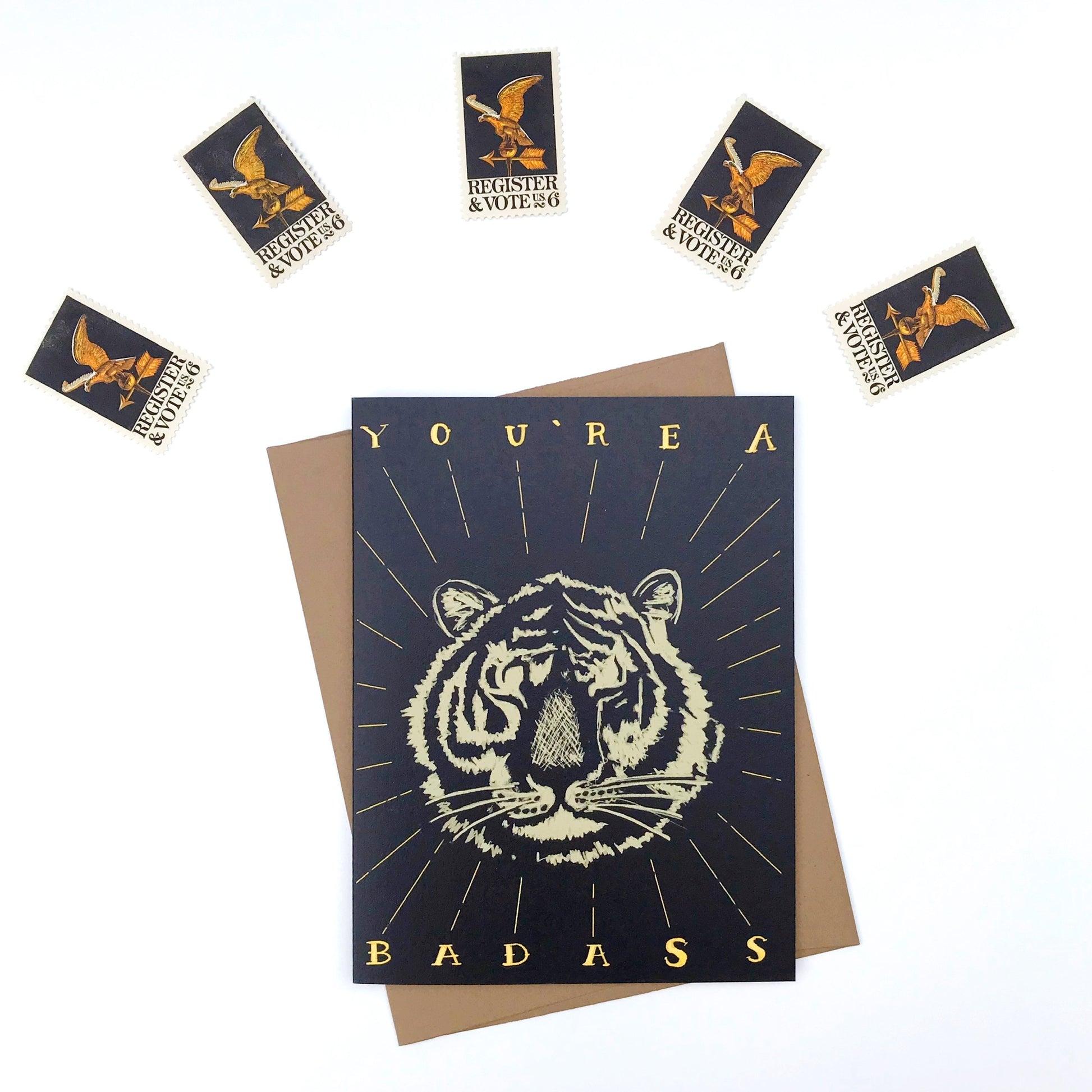 Greeting card with tiger design and text, surrounded by stamps.