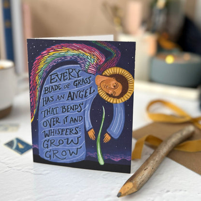 Card with colorful design and text on a surface with a blurred background